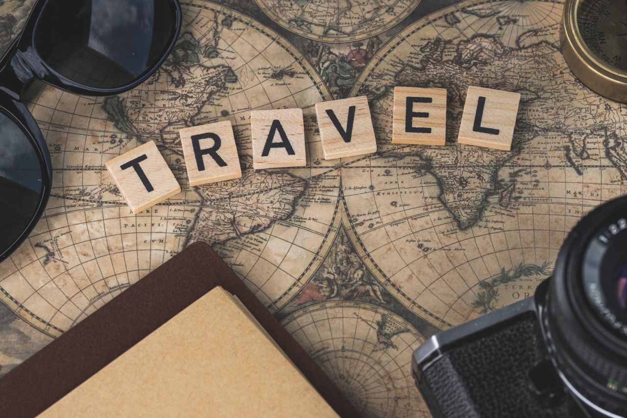 about-us Vintage map with travel essentials like camera and sunglasses arranged in a flat lay, perfect for adventure themes.